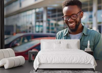 A smiling person using a smartphone to purchase a car Wall mural