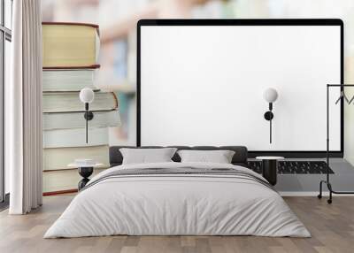 Template for online education - stocks of books next to the laptop with a blank white screen on a desk Wall mural