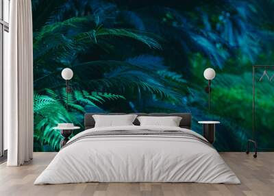 Wide floral background - trendy green dark toned image of tropical bush foliage. Wall mural