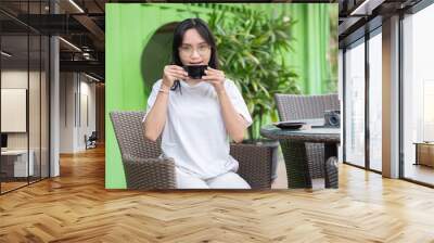 Young Woman Enjoying Coffee at a Cafe Wall mural