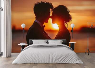 Silhouette of a couple embracing at sunset, with the sun shining between their faces. Wall mural