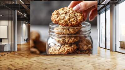 Hand In Cookie Jar. Woman Enjoying Appetising Oatmeal Cookie with Crunchy Texture Wall mural