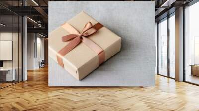 Gift box with brown ribbon on neutral background Wall mural