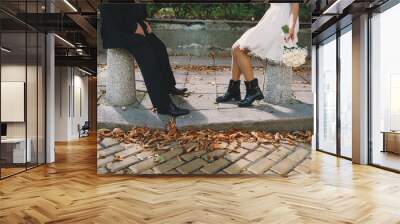 Bride and groom sitting on the sidewalk Wall mural