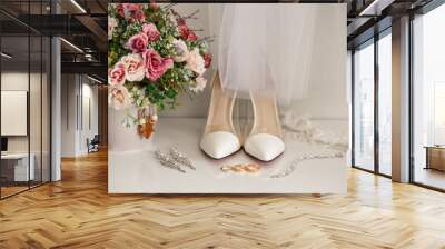 Bridal accessories for luxury wedding day. Marriage concept. Wedding and engagement ring near shoes on high heels, jewelry for bride and bouquet of flowers Wall mural