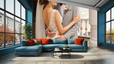 Wedding couple. Bride and groom embracing at wedding day Wall mural