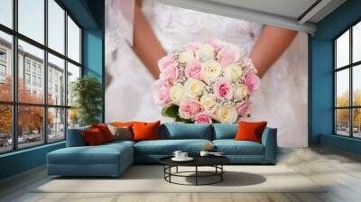 White and pink wedding bouquet with roses in bride's hands Wall mural