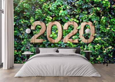 2020 happy new year wood texture number on Green leaves wall background,Nature eco concept,organic greeting card holiday.banner space for adding text Wall mural