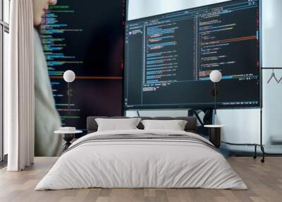 Asian man  prompt engineer develop coding app with software data sitting in front of computer monitor at office Wall mural