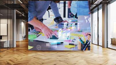 Close up ux developer and ui designer use augmented reality app brainstorming about mobile interface wireframe design on desk at modern office.Creative digital development agency Wall mural