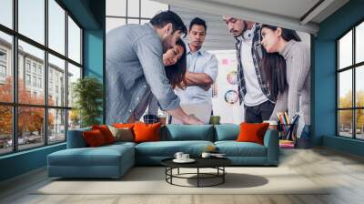 Creative director team lead standing brainstrom branding project with designer team at meeting table.discussion idea in creative office,clap hand for good idea. Wall mural