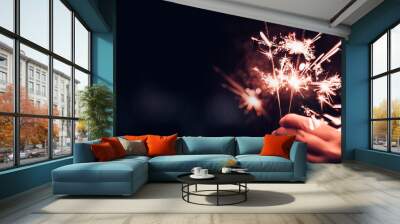 hand holding burning sparkler blast on a black bokeh background at night,holiday celebration event p Wall mural