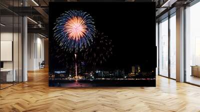 Happy new year fireworks over cityscape at night.holiday celebration festival Wall mural