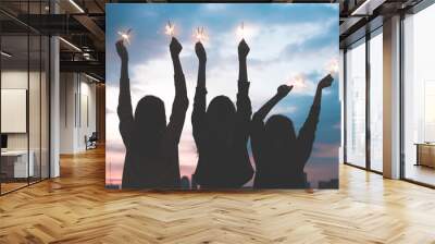 silhouette happy group of asia girl friends enjoy and play sparkler at rooftop party at evening sunset,Holiday celebration festive,teeage lifestyle,freedom and fun Wall mural