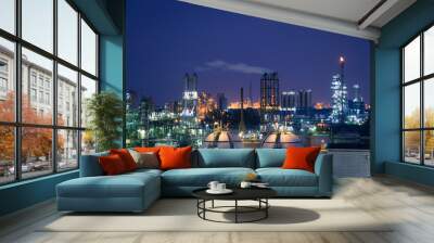 Glitter lighting of petrochemical plant on blue sky twilight background, Manufacturing of petroleum industry Wall mural