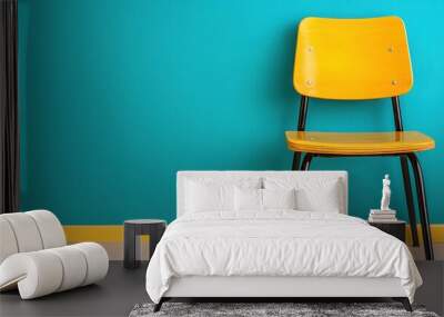 A vibrant yellow chair against a colorful teal wall, perfect for modern interior design and decorative inspiration. Wall mural