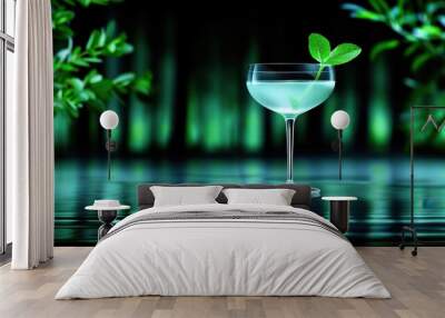 Elegant martini glass with mint leaf garnish on reflective surface, surrounded by lush greenery and soft, ambient lighting. Wall mural