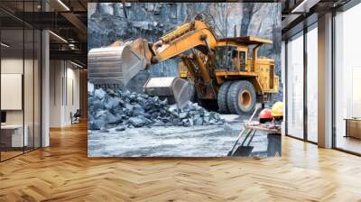 Heavy machinery operates in a stone quarry, moving large rocks and stones efficiently. Wall mural