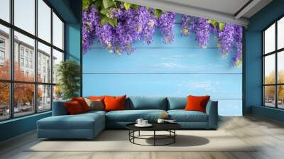 Vibrant purple flowers gracefully draping over a wooden blue backdrop, creating a serene and colorful atmosphere. Wall mural