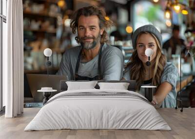 Two colleagues in a coffee shop, laptops open, casual business meeting, warm lighting Wall mural