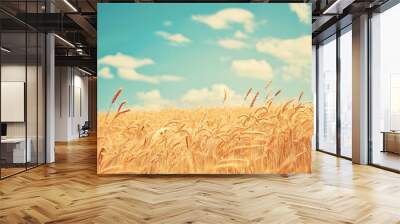 In the foreground, golden wheat fields under blue sky. A warm summer day in nature. Vintage style photo. Beautiful natural landscape background. Wall mural