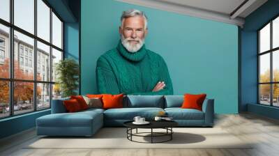 Portrait of handsome gray-haired man with beard in green sweater on color background, studio shot, copy space concept, banner design, copy empty place for text stock photo,


 Wall mural