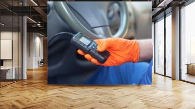 Auto mechanic using car diagnostic scan tool Wall mural