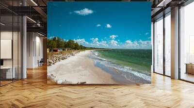 Beautiful sunny beach with white sand, rocks and colorful houses at the clear blue Baltic sea in Ystad, Southern Sweden. Wall mural