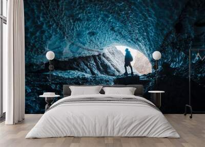 Man silhouette in crystal ice blue cave Wall mural