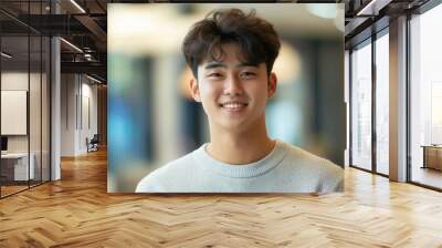 Confident cheerful asian korean young business man guy smiling at camera in light modern office Wall mural