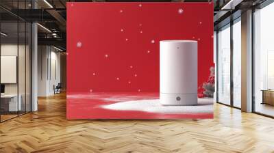 a wireless speaker placed on a cylinder. Red background wall, white snow, equipped with red and white Christmas decorations.  Wall mural