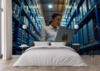 Engineer manager leader woman holding laptop looking at camera at manufacturing factory Wall mural