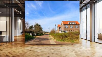 Clinker-built houses in the Dutch town of Bergen aan Zee on a sunny day with a blue sky Wall mural