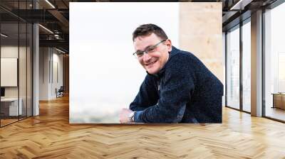 Portrait of a 42 year old white man confident and relaxed standing with a yellow and brown background Wall mural