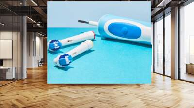 Electric toothbrush on a blue background. Modern technologies for health. Healthy teeth. A modern tool for daily oral care. Wall mural