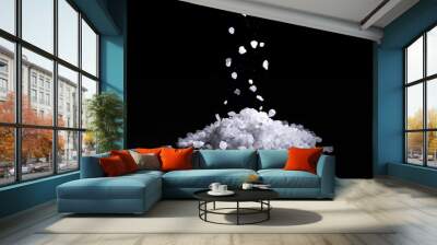 Sea salt crystals fall on a pile of salt, black background Wall mural