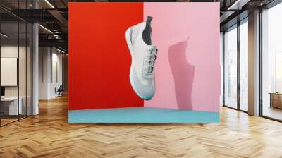 Trendy flying sneakers on creative colorful background. Stylish fashionable shoe. Minimalism footwear concept. Wall mural