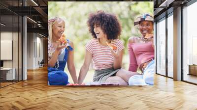 Friends picnic in park, people happy on holiday in New York summer and eating pizza outdoor. Young african women smile with support, fast food diet and girls enjoy nature in happy lifestyle together Wall mural