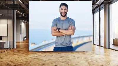 Man athlete, healthy and with cross arms, smile and stand happy outdoor for workout, warm up and wellness..Portrait, confident male and trainer ready for training, fitness and enjoy health exercise. Wall mural