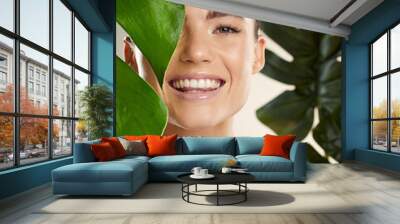 Beauty, skincare and woman portrait with green plant for natural skin dermatology cosmetic product. Happy face of aesthetic model in studio for sustainable glow or makeup for health and wellness Wall mural