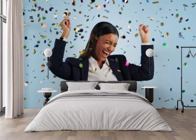 Happy business woman, confetti and celebration for winning or promotion against a blue studio background. Excited female person or employee smile in freedom for victory, achievement or party event Wall mural