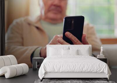 Parkinsons, smartphone and hands of senior man typing online on internet search in retirement home. Phone, elderly person with a disability and scroll on health website, communication or social media Wall mural