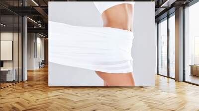 Slim, beauty and fabric around stomach and butt of a young woman after liposuction and wellness. Cloth, isolated and white background of a person with healthy diet aesthetic with silk in a studio Wall mural