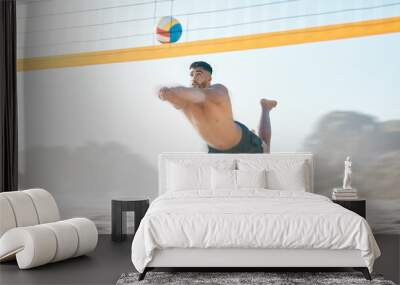 Volleyball, diving and man jump at beach in air for fun competition, contest and motion blur. Male person, outdoor fitness and hit ball at sand by sea for summer games, action and energy performance Wall mural