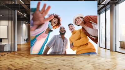 Portrait, smile and a group of friends on a blue sky outdoor together for freedom, bonding or fun from below. Diversity, travel or summer with happy men and women laughing outside on vacation Wall mural