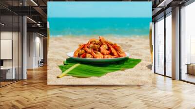 Two glasses of beer by the sea. Plate of food on the beach with delicious appetizer. Perfect vacation. Wall mural