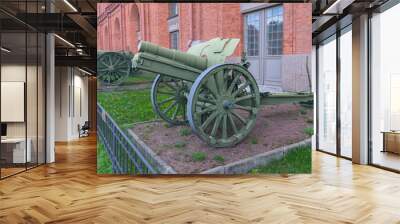 An ancient iron cannon on wheels located in the museum of weapons of the Russian city of St. Petersburg Wall mural