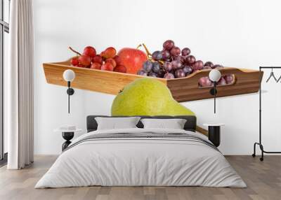 yellow pear, ripe juicy grape brushes and red apple on a wooden tray. Healthy eating concept Wall mural