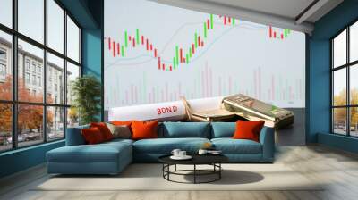 Concept of gold bond showing with Gold bars and Bond paper with Stock Market Graphs or charts in background. Wall mural