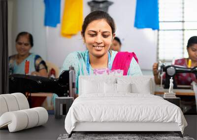 Happy women counting indian currency notes at garment sewing machine - concept of business profit, bonus and financial Wall mural